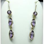 A pair of amethyst earpendants, each hook fronted by a collet set round cut amethyst suspending an