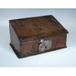 A 17th century oak bible box with chip carved lectern, the front carved with the initials TB 17 x 33