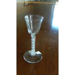 An 18th century opaque twist wine glass, the rounded conical bowl on double helix stem and