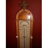 An oak Admiral Fitzroy barometer, late 19th century, the arched case with glazed front displaying