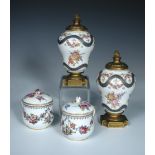 Two Sevres custard cups and covers, one with date letter for 1776, painted with floral swags and