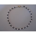 A pearl and labradorite necklace, composed of 5-6mm white pearls each spaced by two faceted rondel