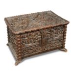 A 17th century continental carved oak chest, profusely carved with ironwork lock plate to the hinged
