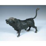 A late 19th/early 20th century bronze model of a bull, with dark brown patina, lacking his horns