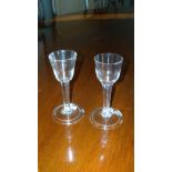 Two similar 18th century wines with clear stems and folded feet, 14cm (5.5 in) high (2)