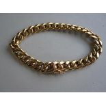 An Italian 18ct gold curb link bracelet by Unoaerre, the flattened polished links to a masked