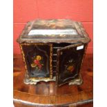 A Regency lacquered papier maché table cabinet, painted with shell motifs and two floral painted