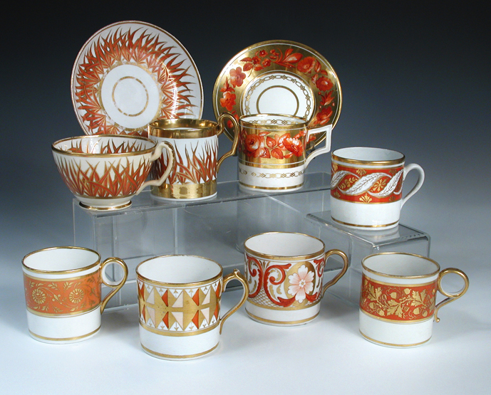 Ten Regency coffee cans decorated in a similar palette, all with orange and gilt painted patterns,