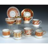 Ten Regency coffee cans decorated in a similar palette, all with orange and gilt painted patterns,