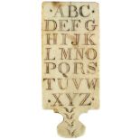 A rare ivory alphabet hornbook circa 1800, the paddle shape engraved with capital letters of the