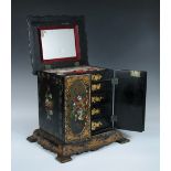 An early Victorian papier maché jewellery cabinet, the lid, doors and sides painted and mother of