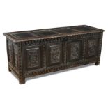 A late 17th century Continental oak panelled chest, the four panelled front carved with Romayne
