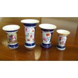 Four blue ground spill vases, each painted with floral reserves within gilding between bead