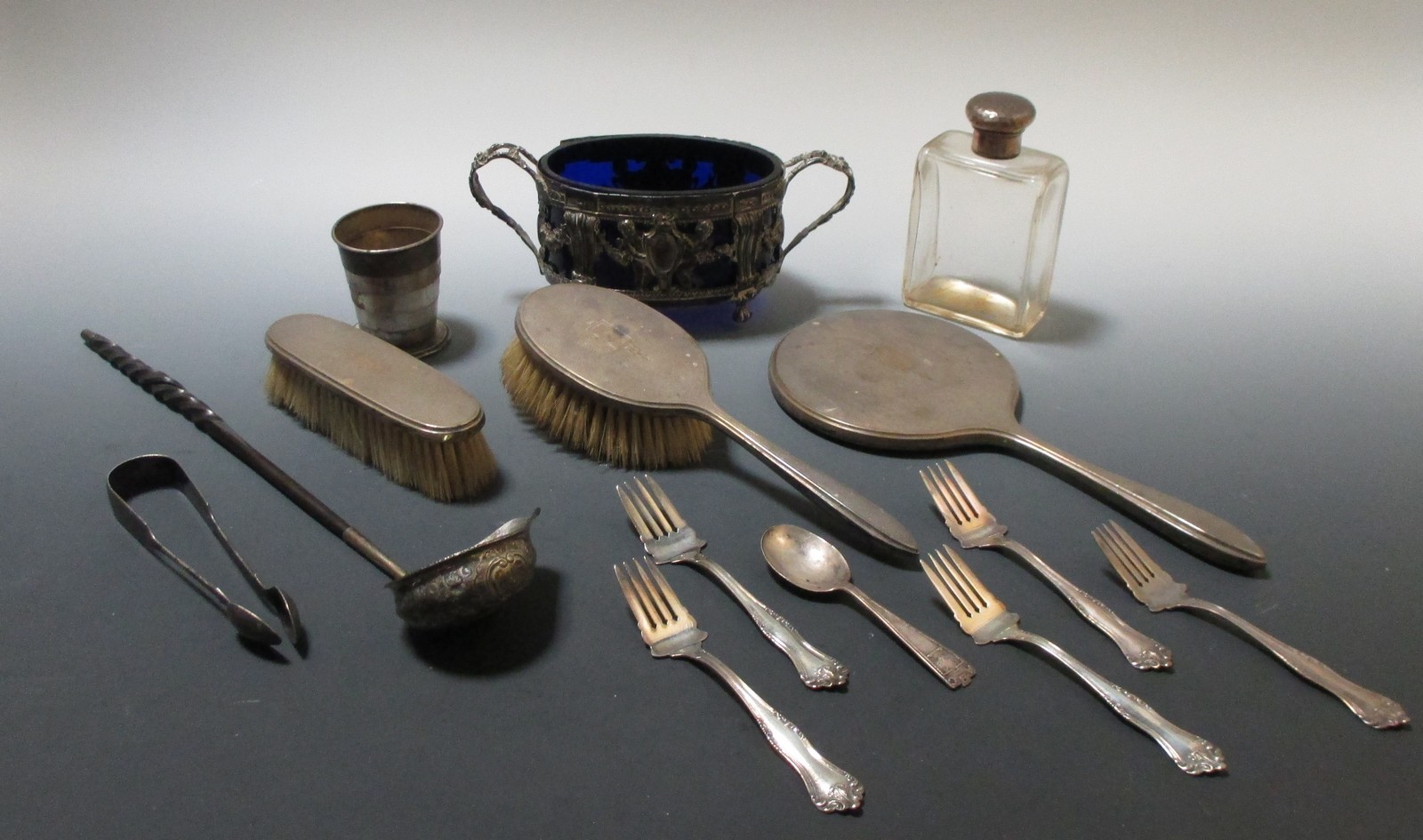 Silver, various: sterling picnic cup, 5 small forks and a spoon; silver capped glass bottle; damaged