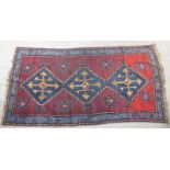 An Afghan blue ground rug, 215 x 110