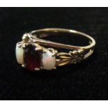 A 9ct opal and garnet ring, hallmarked London 1977, size M