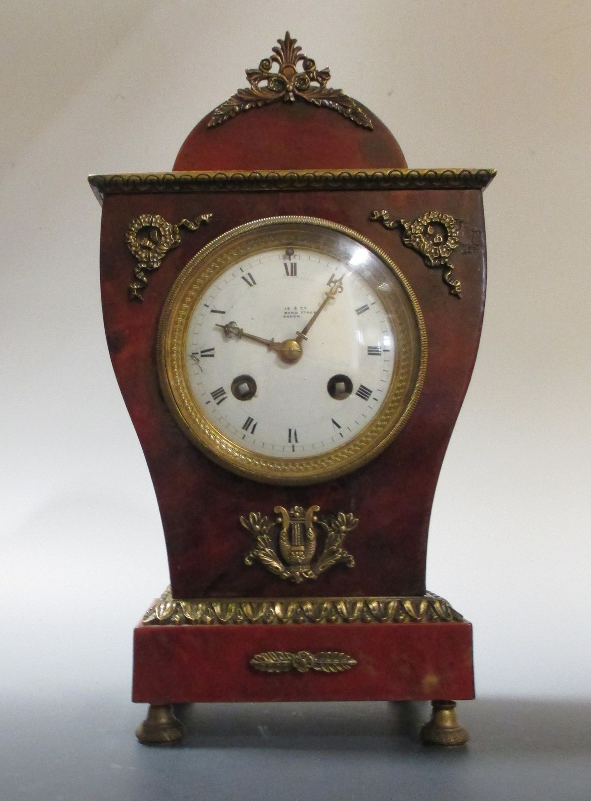 A late 19th century red tortoiseshell and ormolu mantle clock