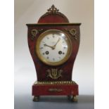 A late 19th century red tortoiseshell and ormolu mantle clock