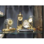 Three Anniversary clocks and a brass mantle timepiece with screw back and silvered dial