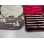 A cased pair of silver trifle spoons and a case of six silver handled teaknives