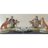 A pair of Staffordshire figures, milkmaid and man each standing with a cow together with a pair of