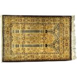A small Kashmir silk prayer rug, India, decorated with hanging lanterns 97 x 61cm (38 x 24in)