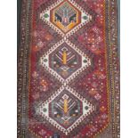 A Turkish runner on a red ground with a floral border, 300 x 95cm