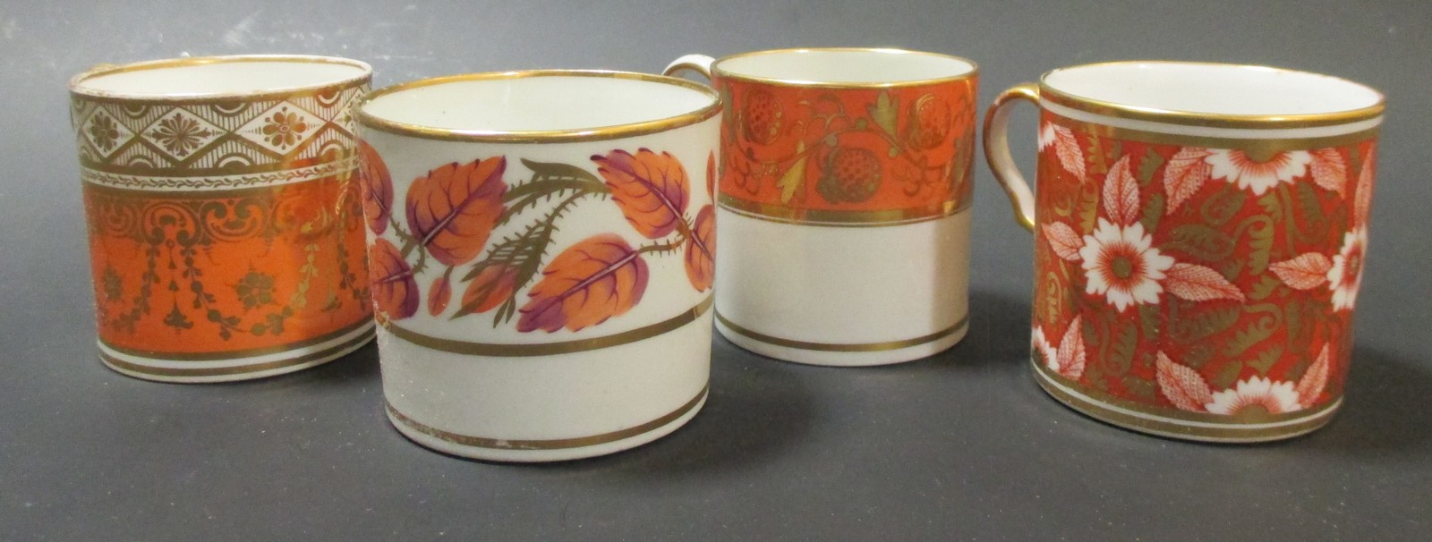Sixteen early 19th century coffee cans decorated in oranges & gilt inc. Worcester, Coalport, Spode &