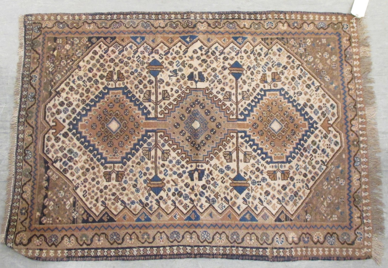 A Turkish rug on a coffee ground, 145 x 103cm