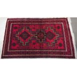 A Turkish rug on a red ground with multiple borders, 235 x 152cm