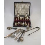 A pair of silver sugar tongs, a christening spoon, a silver tea infuser and a quantity of tea