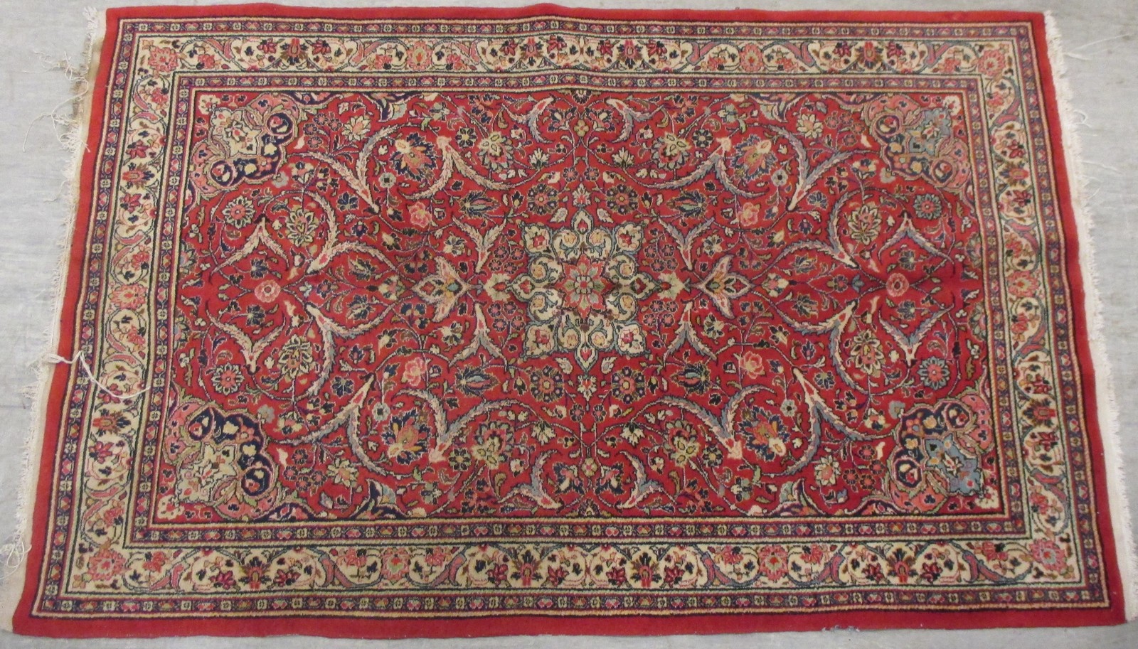 An Persian rug on a red ground with multiple borders, 213 x 133cm