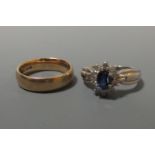 A sapphire and diamond ring, the oval cut sapphire, approx 5.9 x 4.1mm nad claw set, surrounded