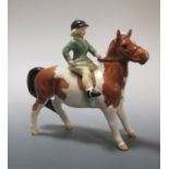 A Beswick model of a girl on a pony