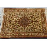 A small silk rug, floral designs on a camel ground 98 x 62cm (38 x 24in)