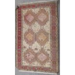 A faded pink ground rug, 130cm x 200cm and a modern red ground rug 125cm x 207cm (2)