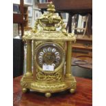 A 19th century French gilt metal mantle clock with cant wheel and bell striking movement