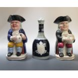 Two early 20th century Staffordshire Toby jugs and a Copeland 1911 commerative whiskey bottle