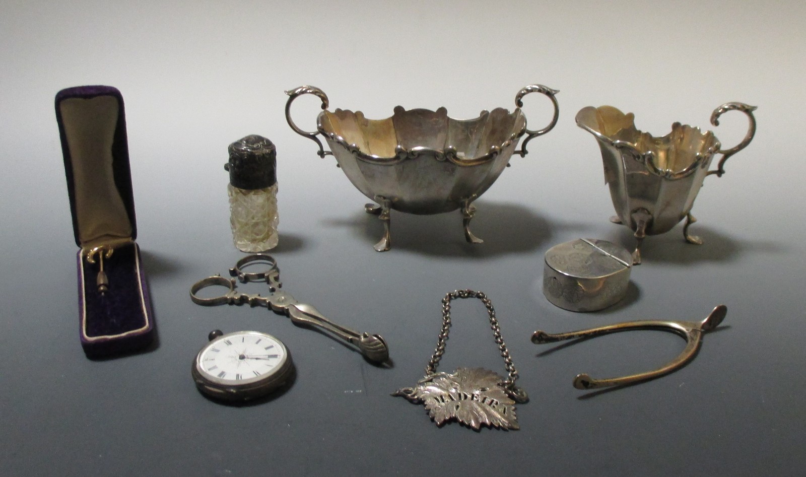 A matching silver cream jug and sugar bowl by HM, Brimingham 1895, with facetted tapering bod and