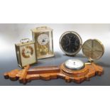 A small oak barometer by W E Pain, Cambridge together with four 20th century mantle and carriage