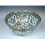 A 19th century Canton punch bowl, the central roundel painted with figures watching warriors on