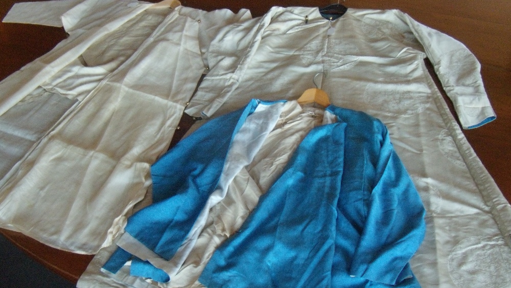 A blue silk jacket, matching pattern cream trousers, underclothes and a full length cream silk robe,