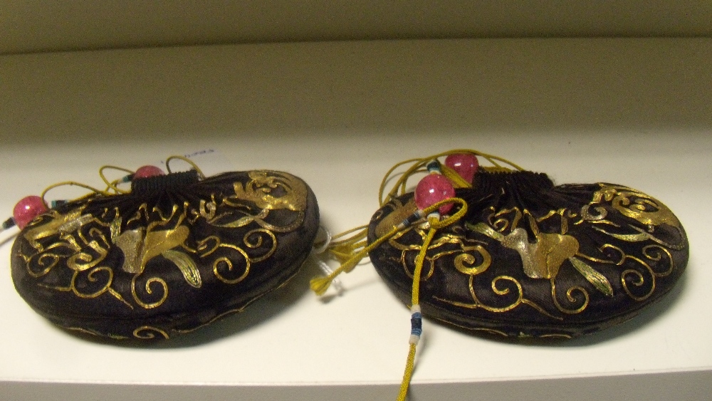 A pair of embroidered black silk purses, the heart shapes worked in gold threads with finger - Image 2 of 2