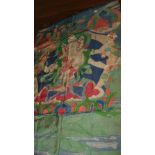 A Tibetan sewn silkwork thangka depicting a three headed deity with a bow, sword, pen and book in