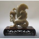 A hardstone figure of a phoenix, on a carved wooden base, 19cm tall