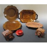 A collection of treacle and brown ware, together with a pair of lion rests