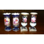 Two pairs of blue ground spill vases, the first with wavy rims above flower reserves and socle feet,