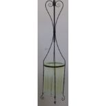 An Arts & Craft style wrought iron hanging lantern with a vaseline glass shade