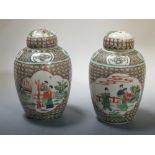 A pair of Kangxi style famille verte jars and covers, 22cm high