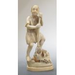 A Japanese marine ivory carving of a standing fisherman, 12cm high